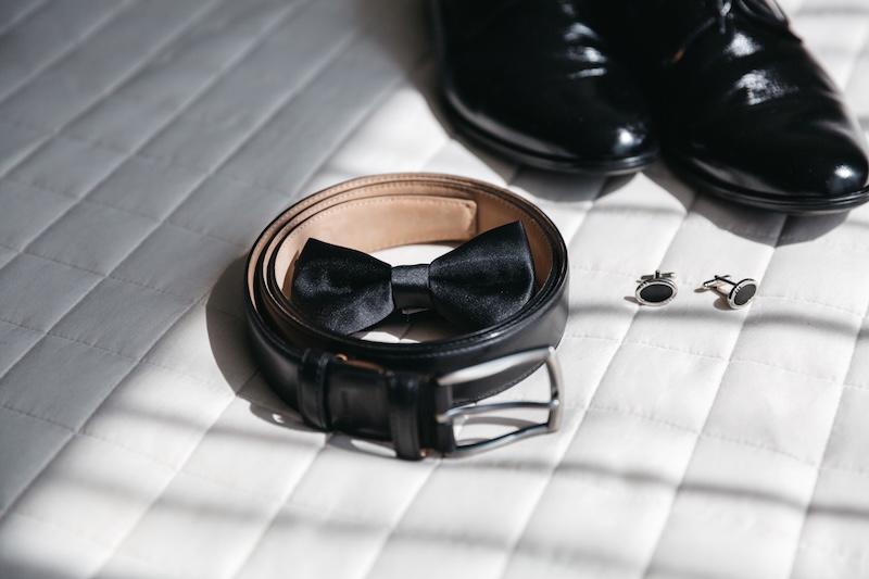 A black belt, bowtie, shoes, and cufflinks - Essential accessories for suits in Pearce Bespoke 