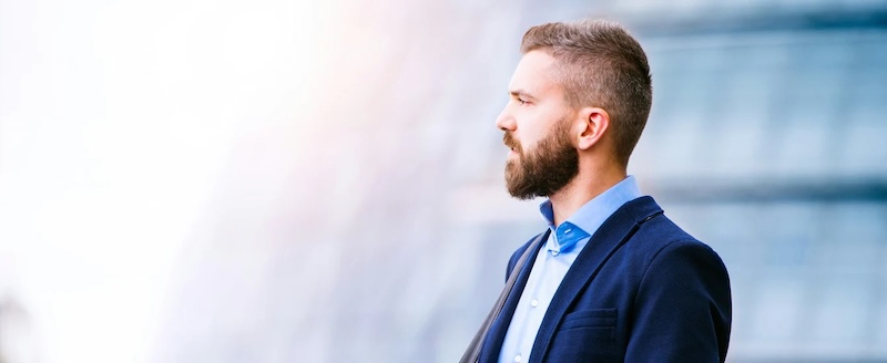 A man in a blue custom shirt made by Pearce Bespoke - Deliver Unparalleled Client Satisfaction in Your Bespoke Suit Franchise