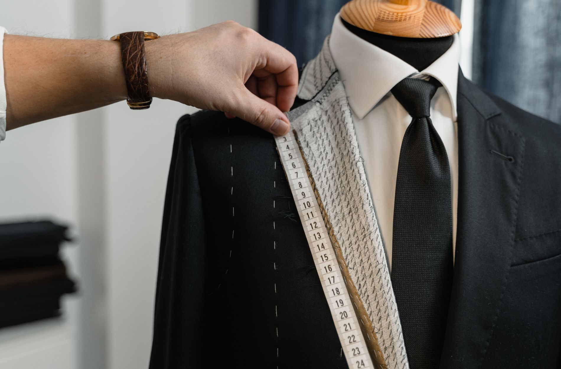 An image of someone using measuring tools for a custom garment - learn why fit is the most important part of custom clothing with Pearce Bespoke.