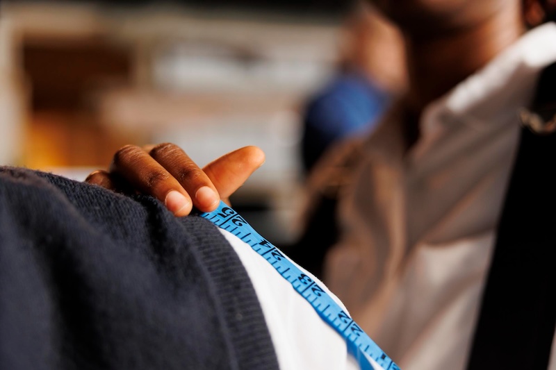 A man measuring a Pearce Bespoke bespoke suit - learn more with Pearce Bespoke 