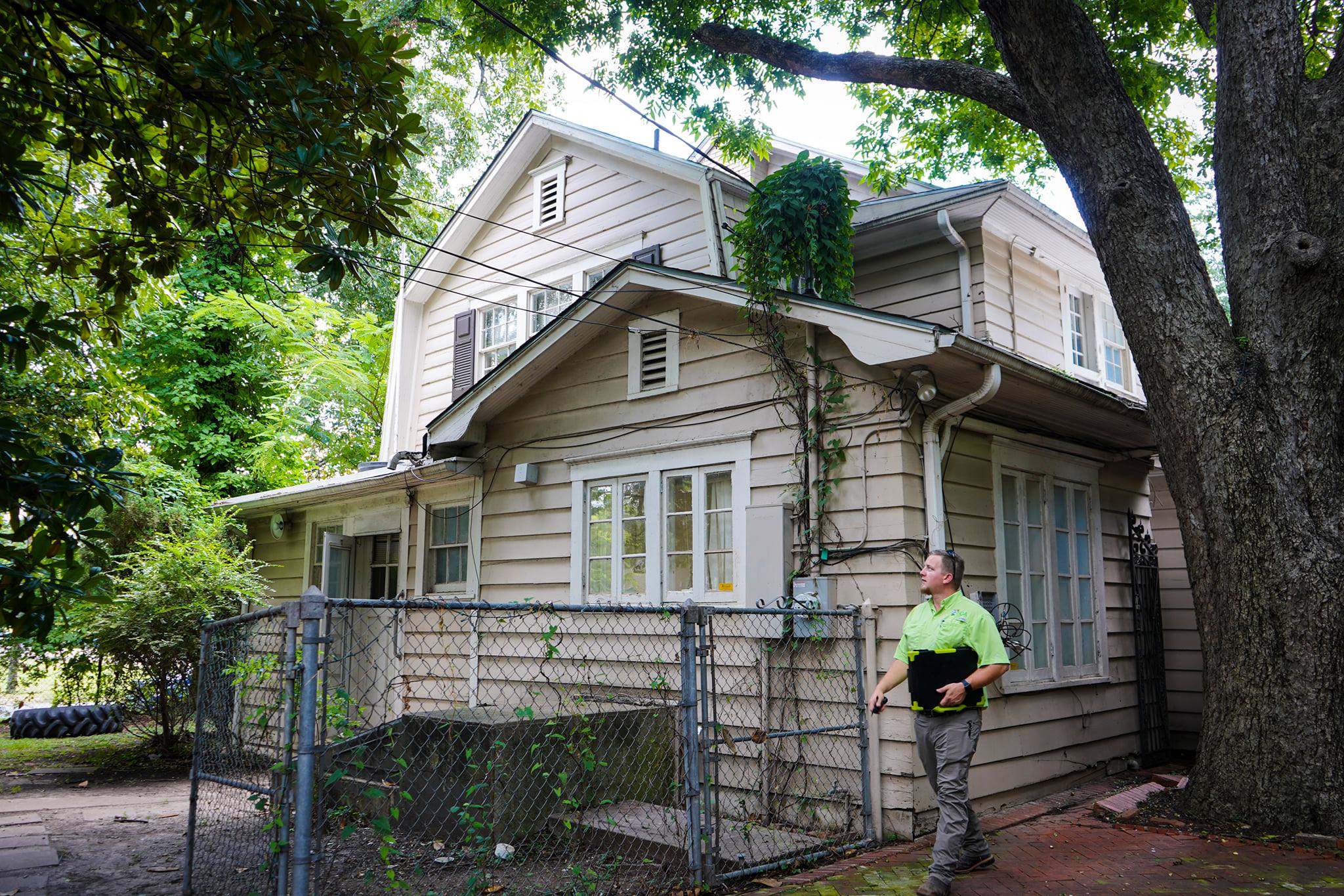 {fran_brand_name technician outside of residential home.