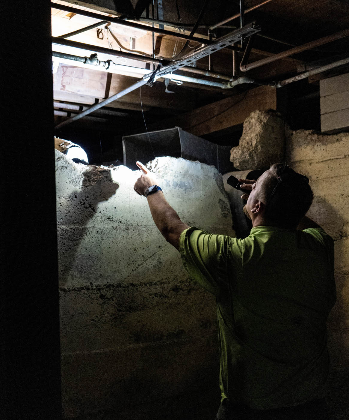 A GGA Pest Management Waco technician performing an inspection for termites.