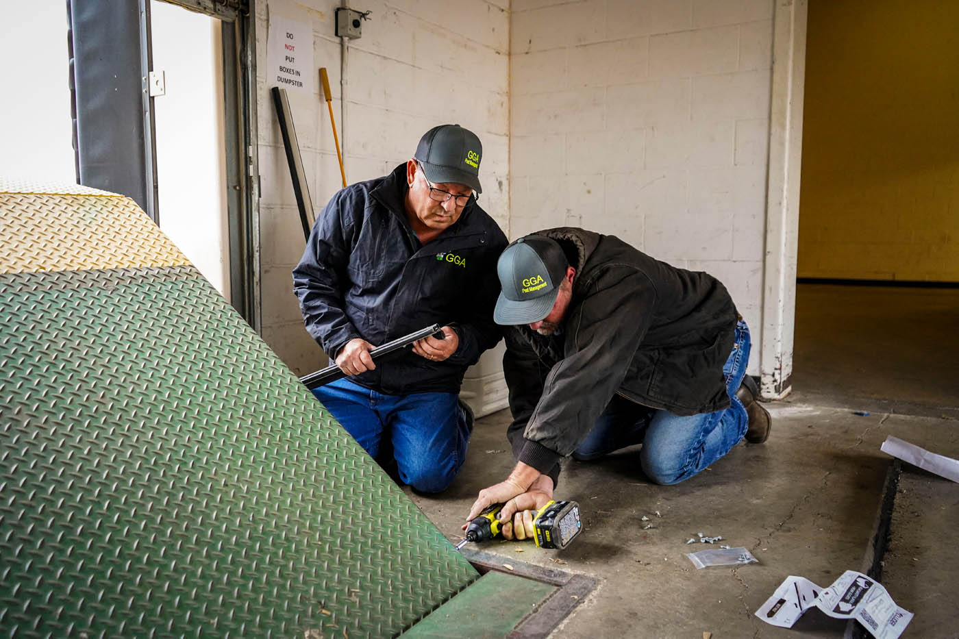 Two GGA Pest Management technicians working on a residential home as reliable pest killers.