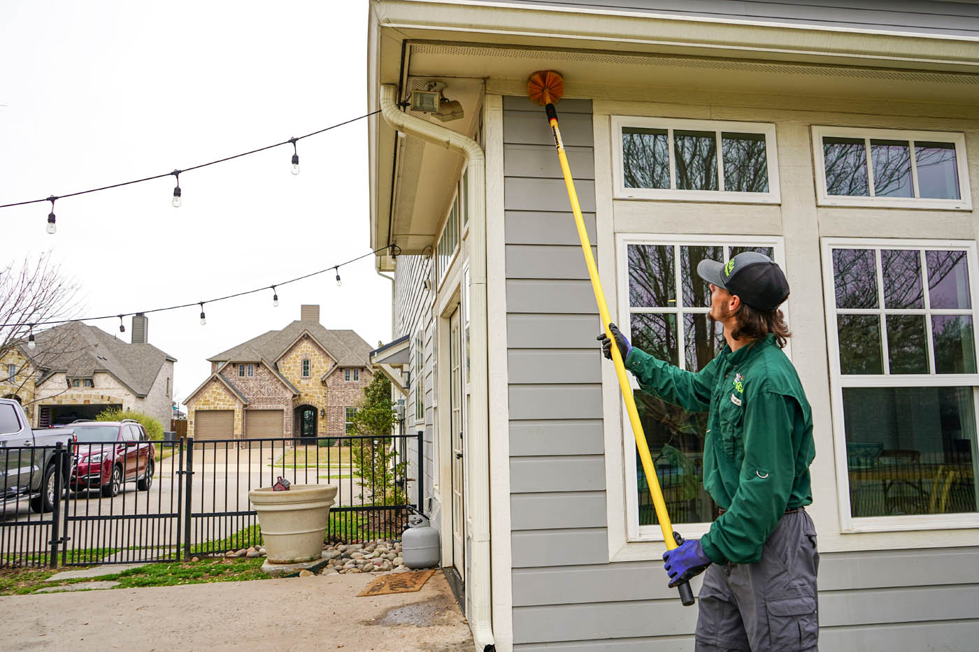  GGA Pest Management technician in a green shirt working on Hillsboro pest control services. 