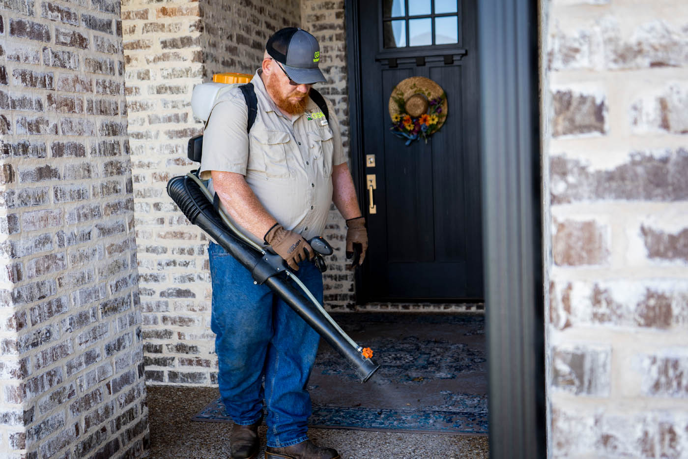 A GGA Pest Management technician working on spraying a residential home.