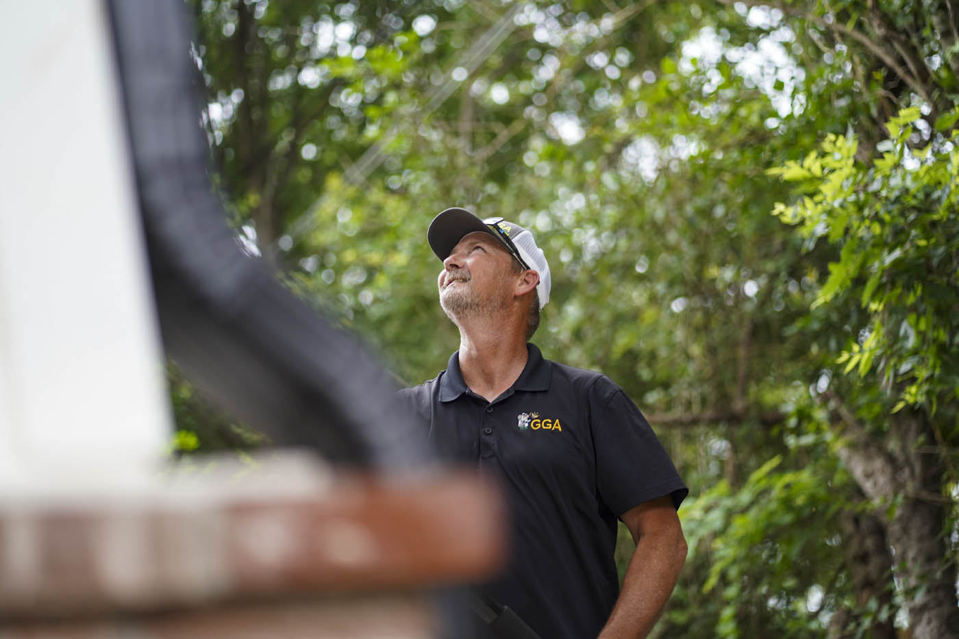 A GGA Pest Management animal exterminator inspecting a home for critters.