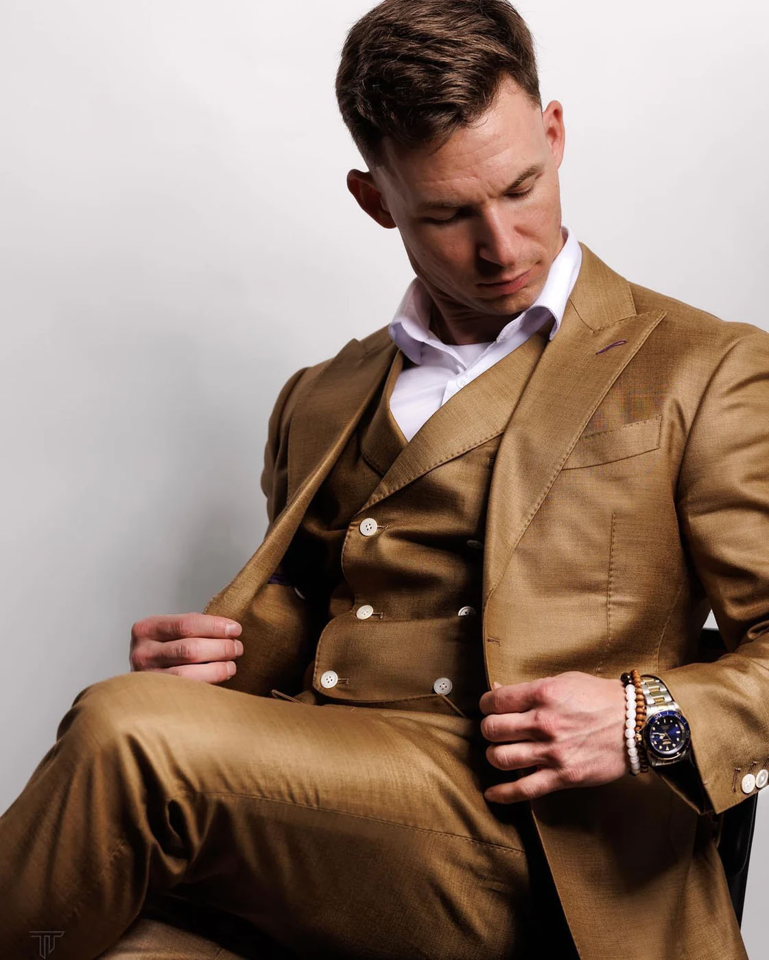 A man in a stunning tan custom suit from Pearce Bespoke.
