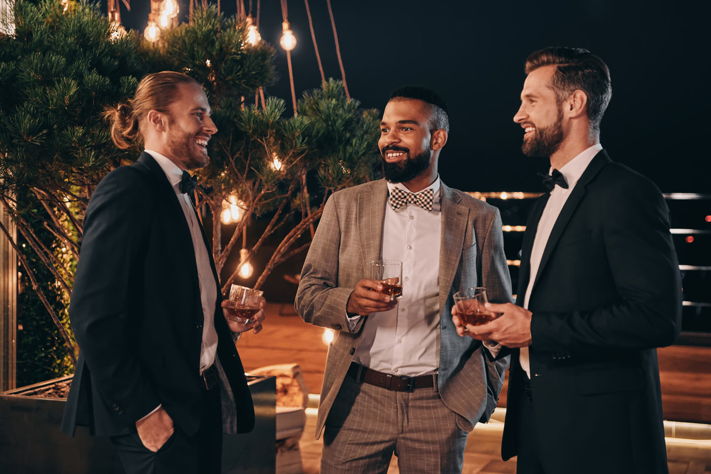 A group of men at an event in custom suits created by Pearce Bespoke.