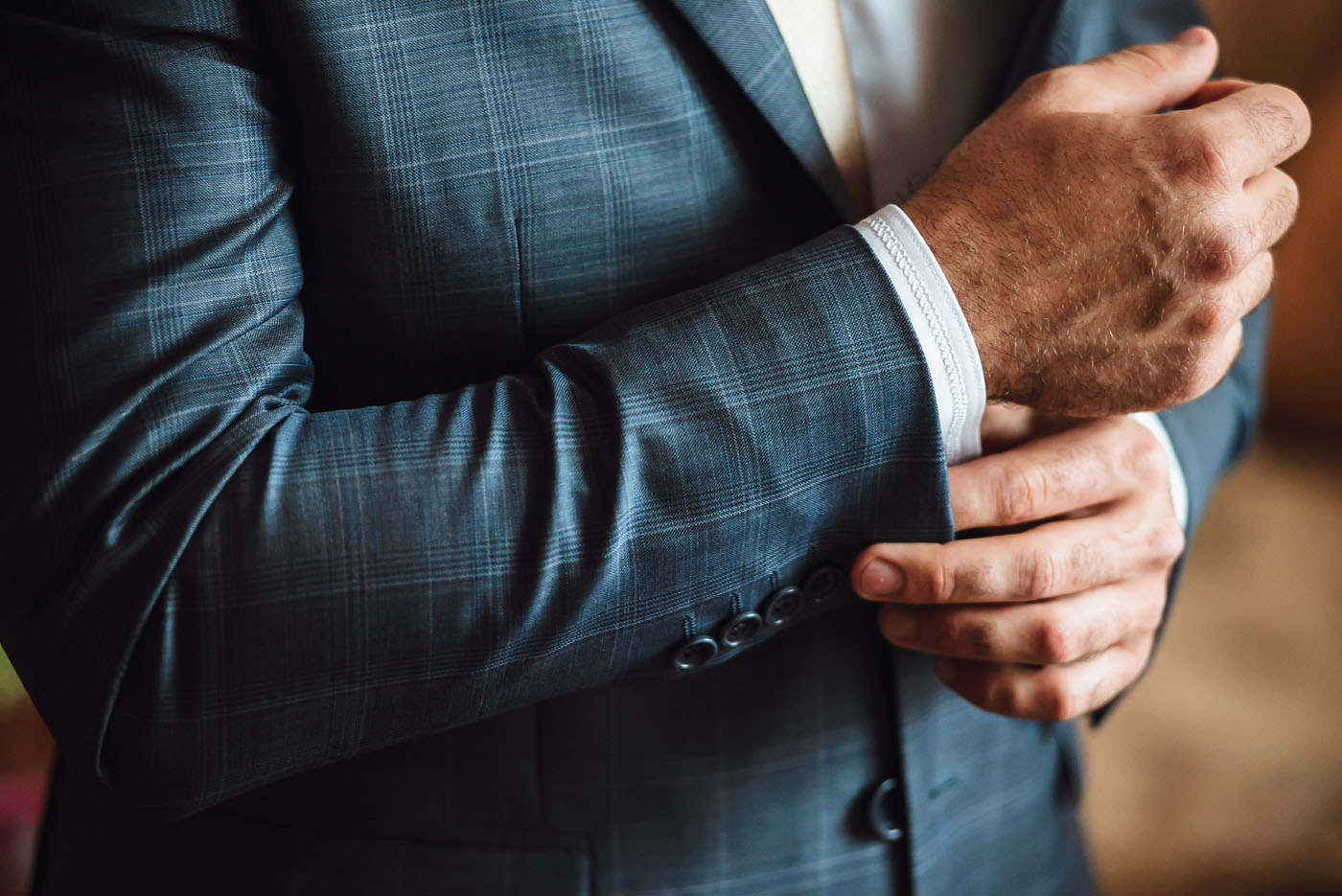 A close up of a person in a custom fitted suit - learn more about elevating your entrepreneurial game with Pearce Bespoke.