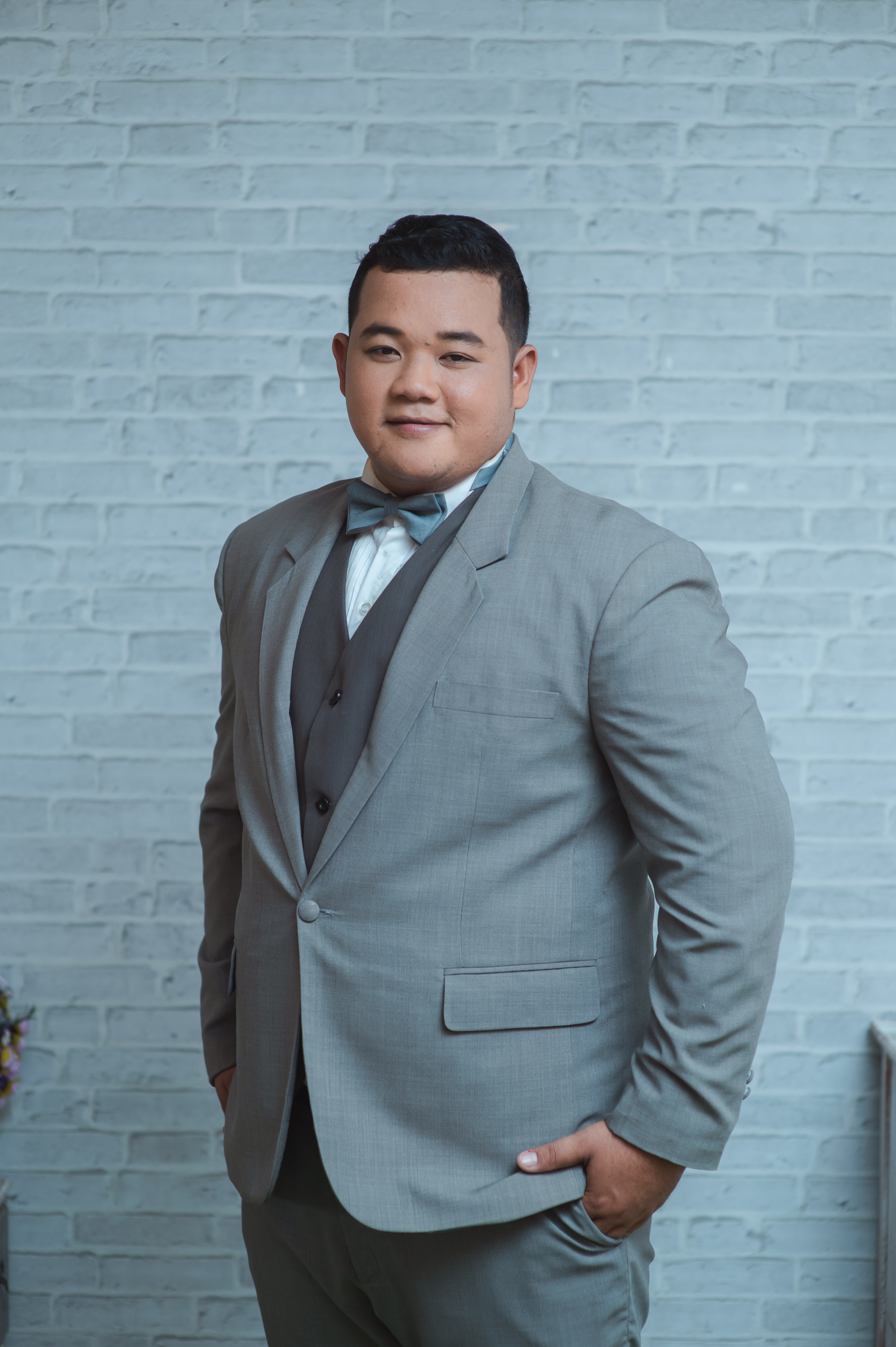 A man wearing a gray colored custom suit from Pearce Bespoke.