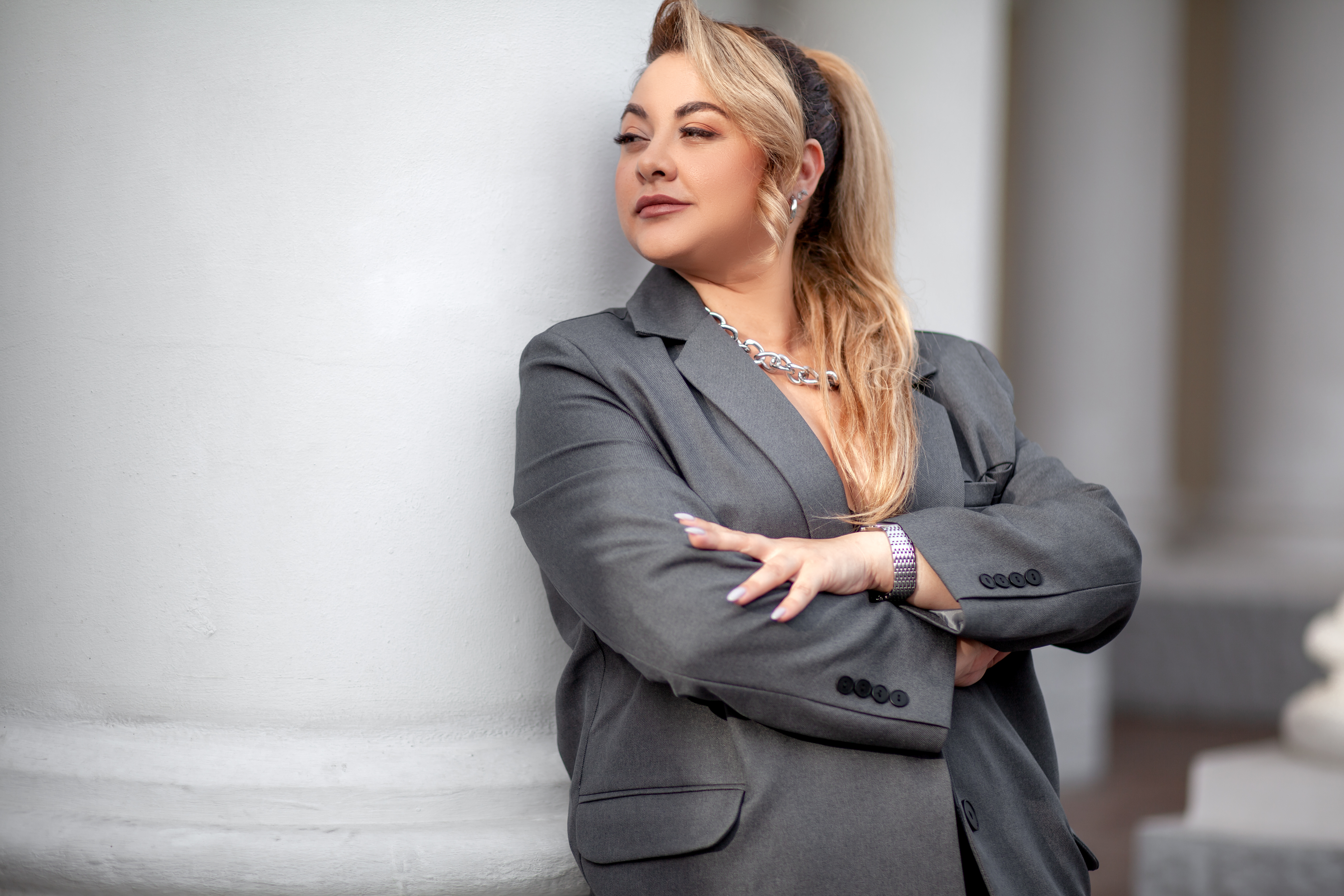A professional photo of a woman in a Pearce Bespoke plus size womens tailored suits.