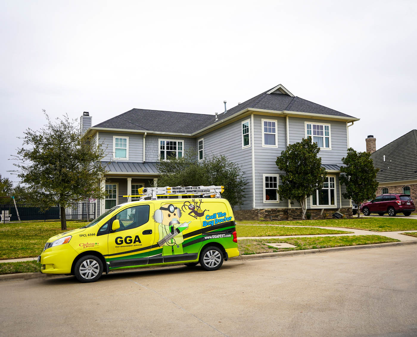 A GGA Pest Management vehicle in front of a residential home - learn how we can help with our roach exterminator services.