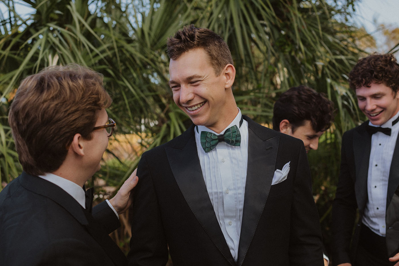 A groomsman and his entourage in custom suits created by the Pearce Bespoke suit tailors.