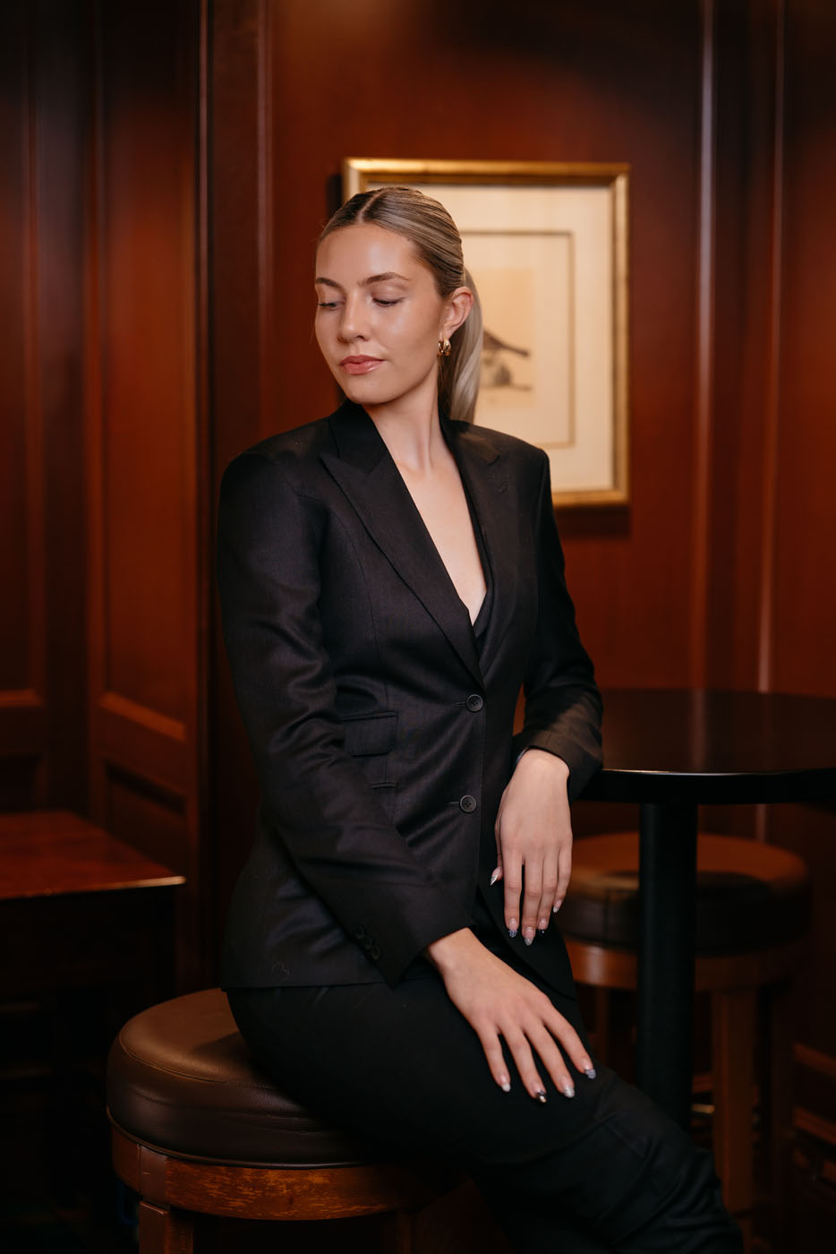 A woman wearing a bespoke black suit created by Pearce Bespoke - for executive suits, reach out today.