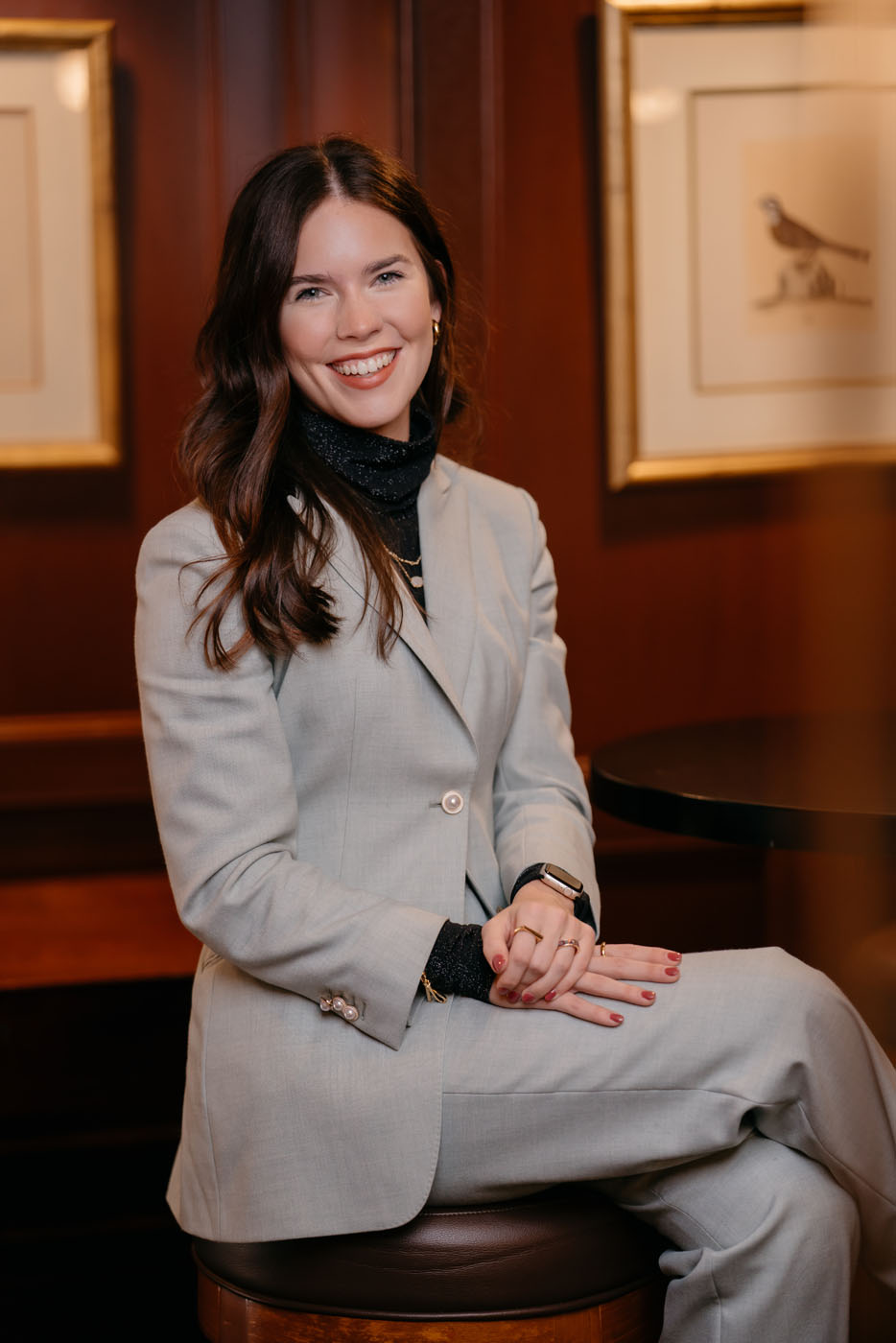 A professional woman wearing a gray suit - get womens professional suits from Pearce Bespoke.